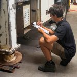 Technician assessing an elevated work platform after inspection findings